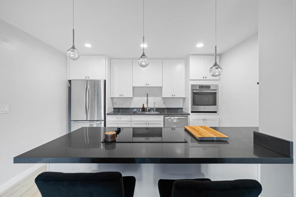 a kitchen with kitchen island a sink appliances and cabinets