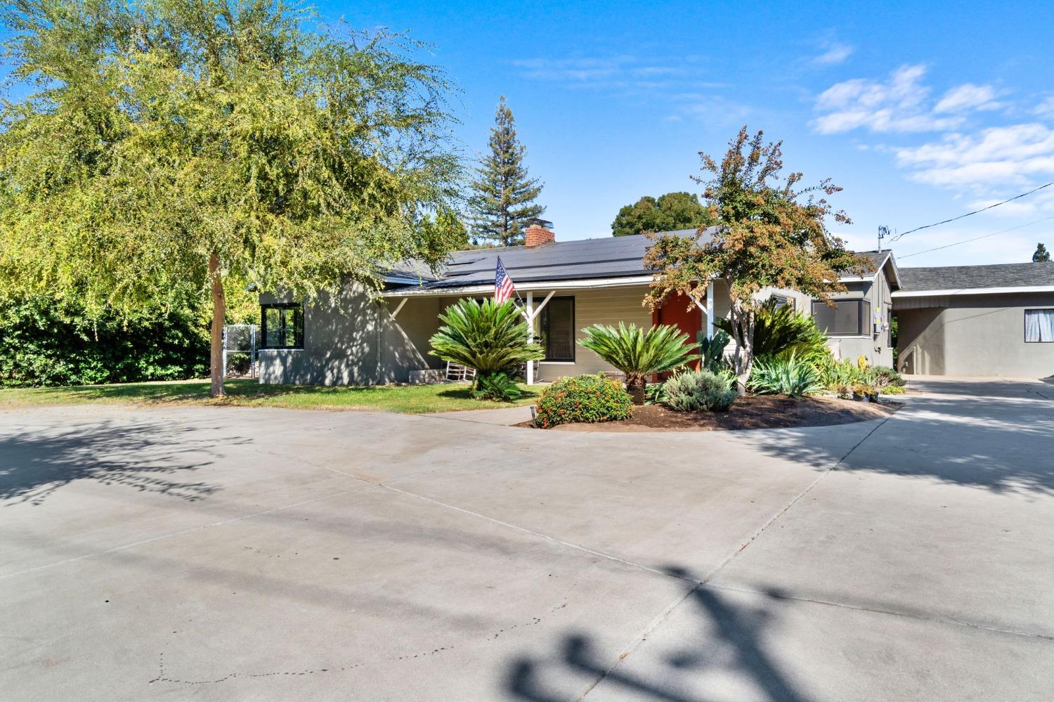 a front view of a house with a yard and a garage