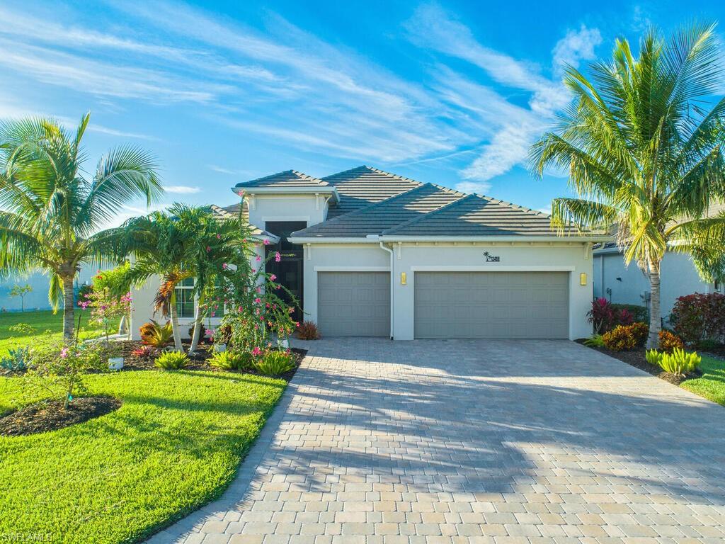 View of front facade featuring a front lawn and a garage