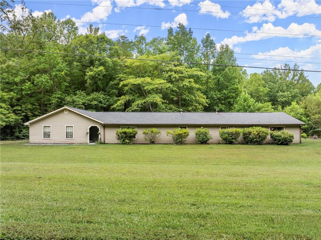 a view of a big yard with a house in the background