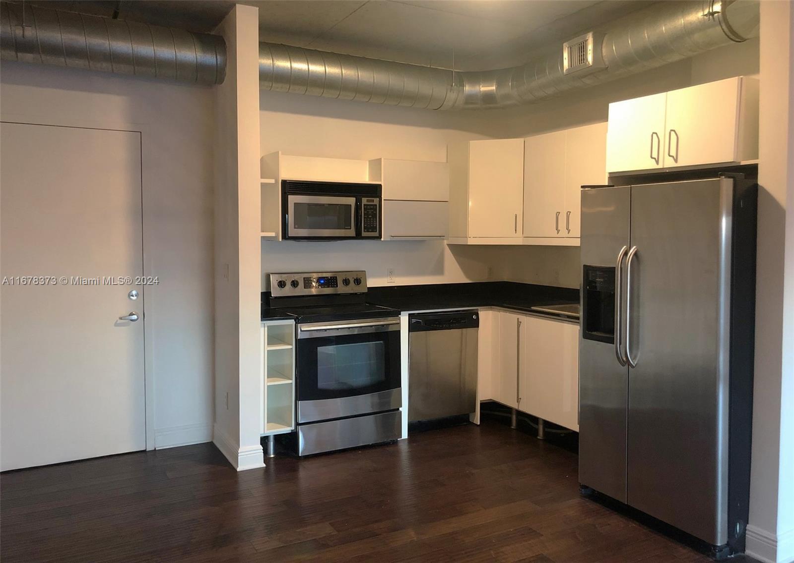 a kitchen with a refrigerator stove and microwave