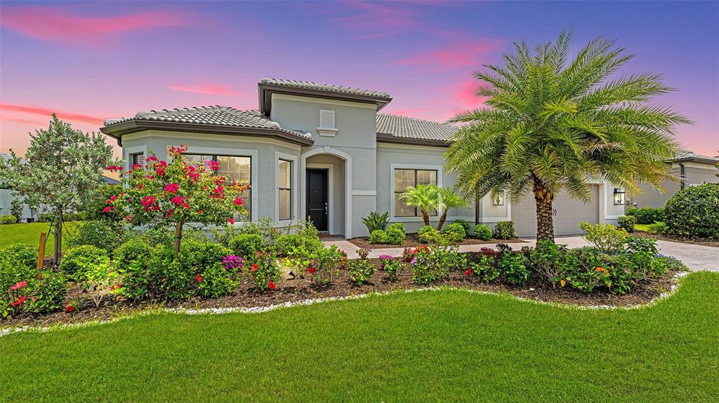 a front view of a house with a garden