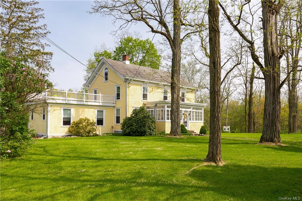 a front view of house with yard and green space