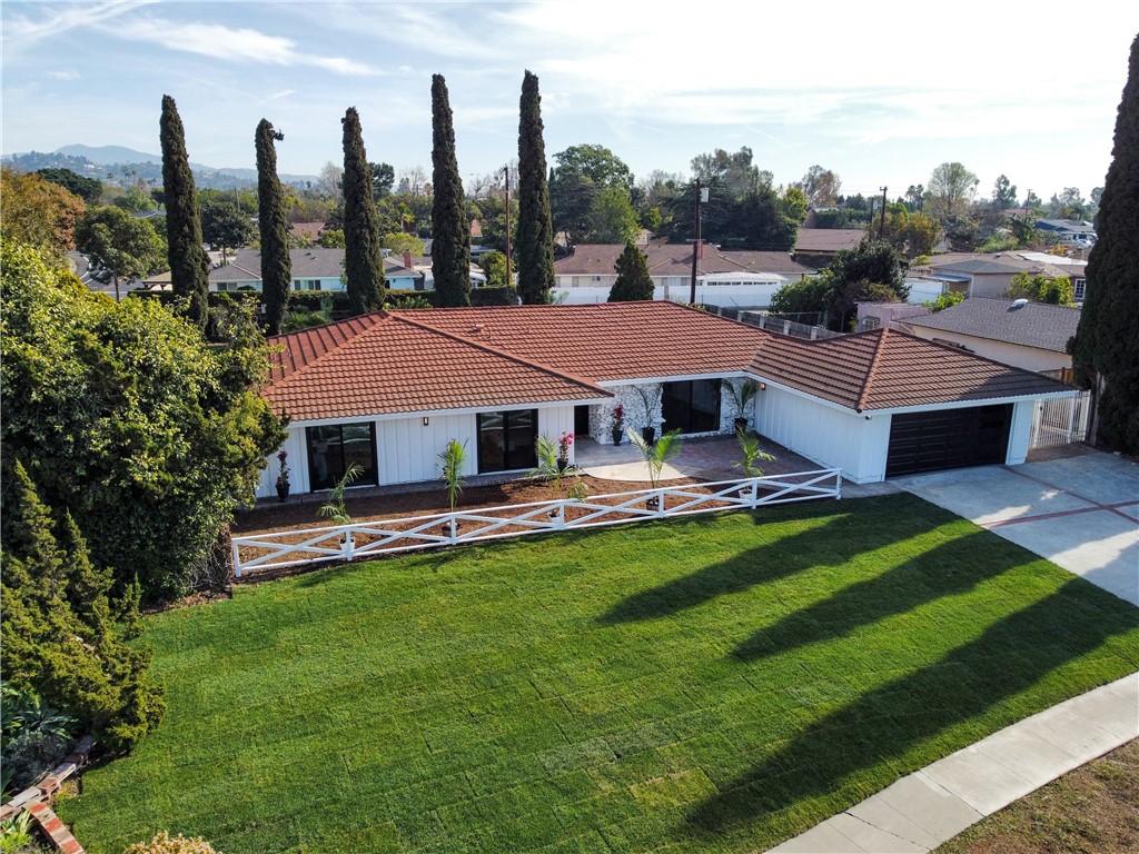 a aerial view of a house with swimming pool and a yard