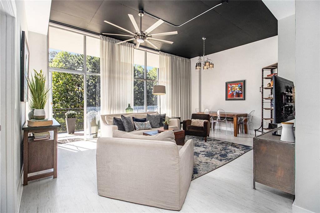 a living room with furniture tv and a large window