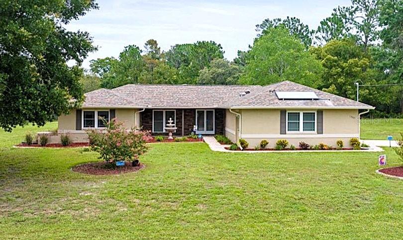 a front view of a house with a garden and porch