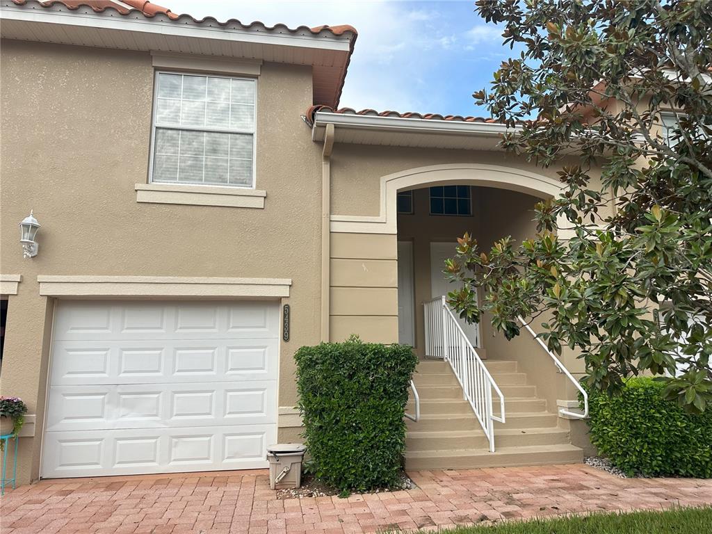 a front view of a house with a yard and garage