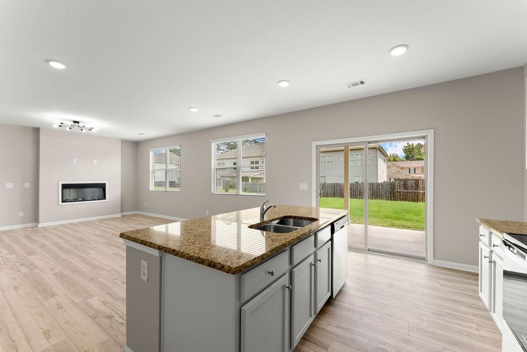 a kitchen that has a sink and a wooden floor