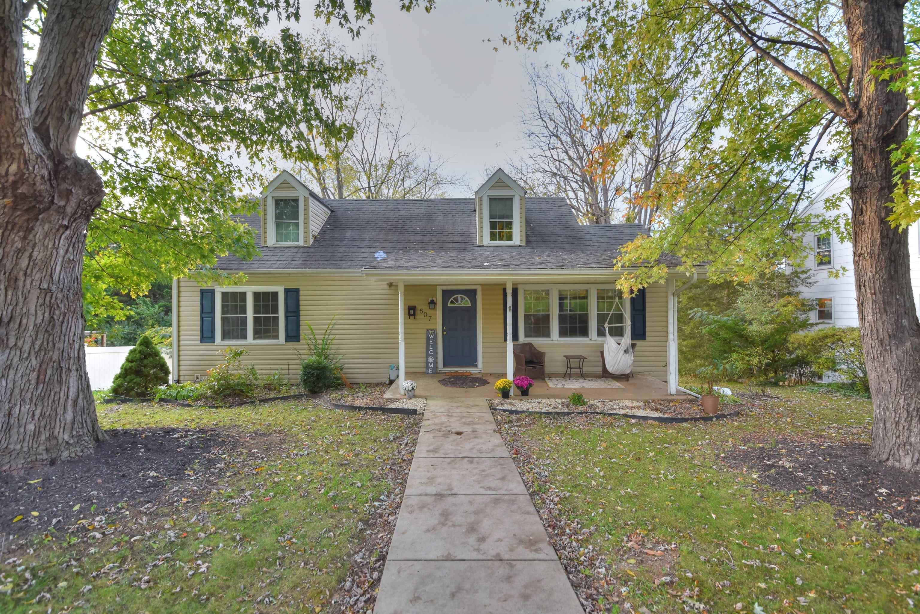 a front view of a house with garden and porch