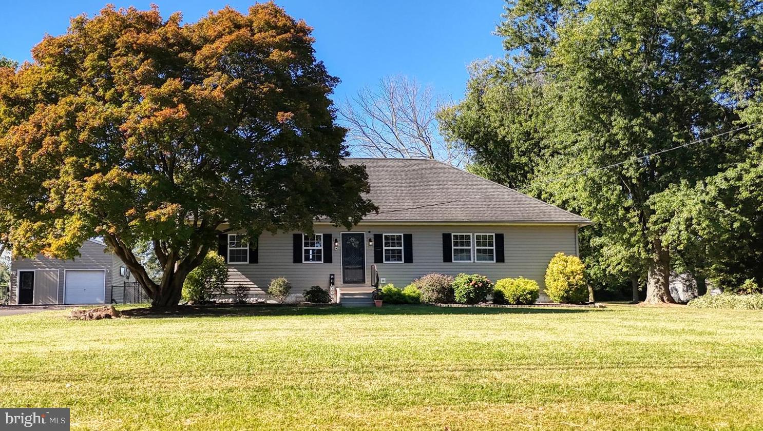 a front view of house with an outdoor space and trees