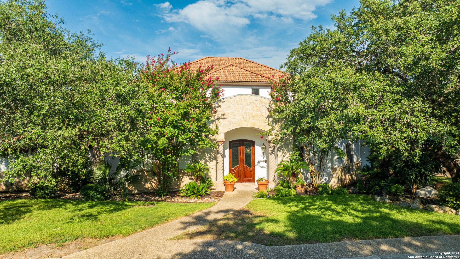 a front view of a house with a garden