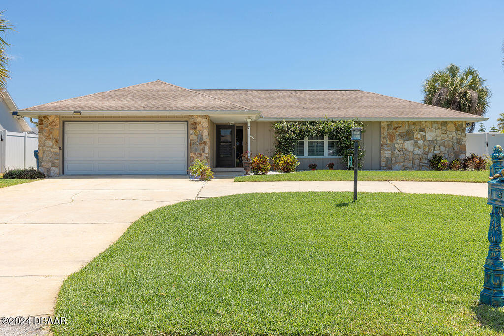 a view of a house with a backyard and a patio