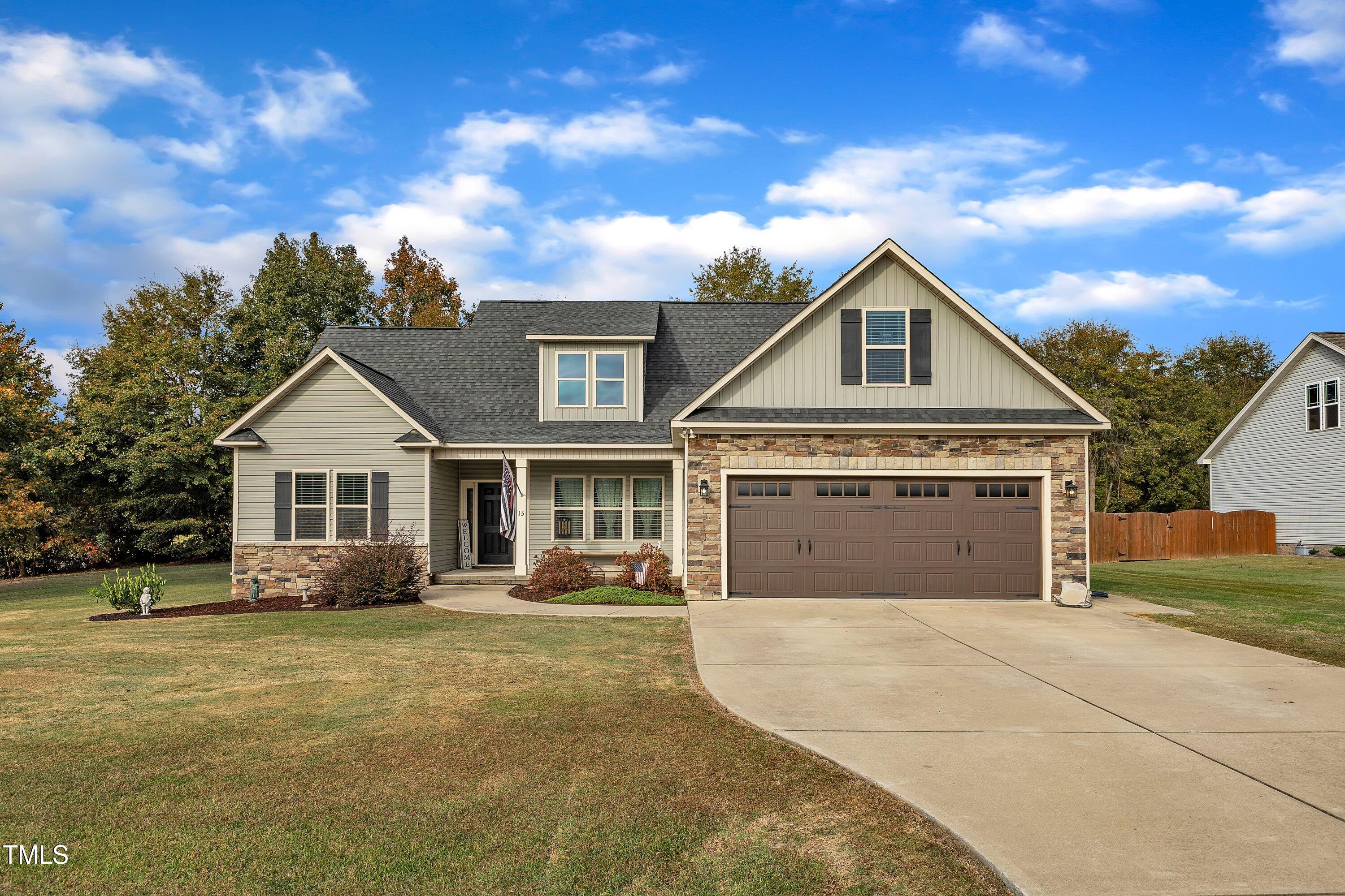 a front view of a house with a yard and trees