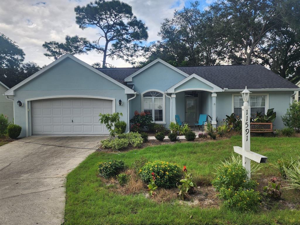 a front view of a house with a garden and yard