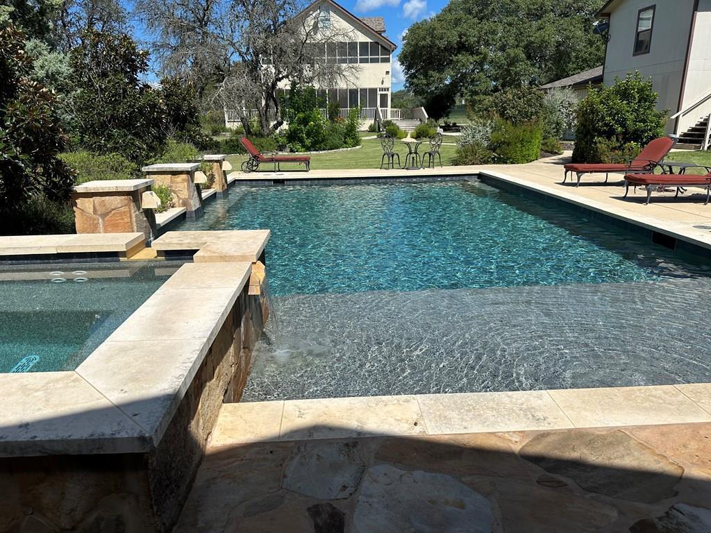 a view of a swimming pool with a yard