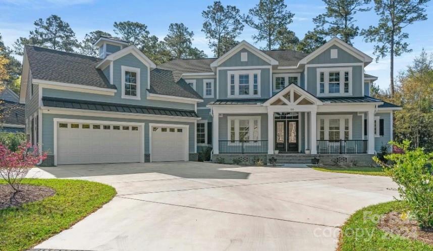 a front view of a house with a garden and garage