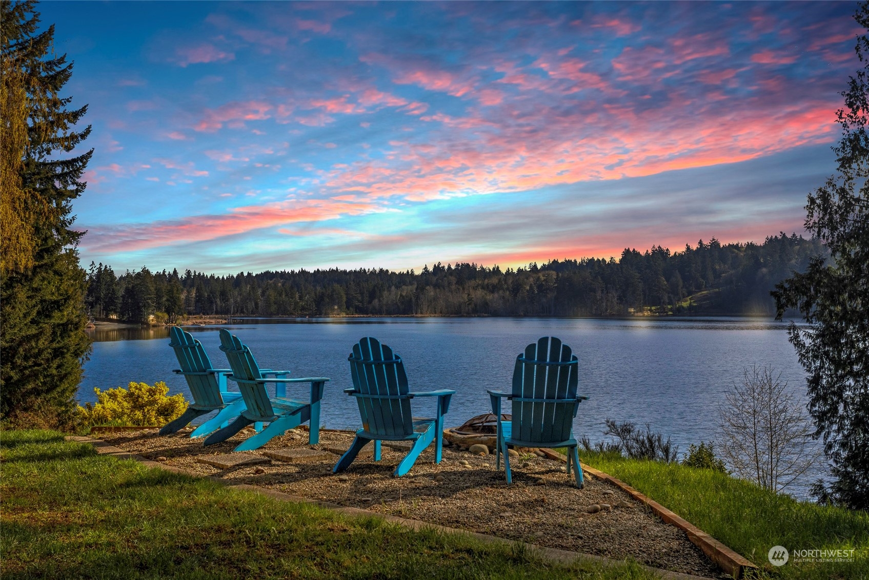 a view of a lake in the backyard of a house