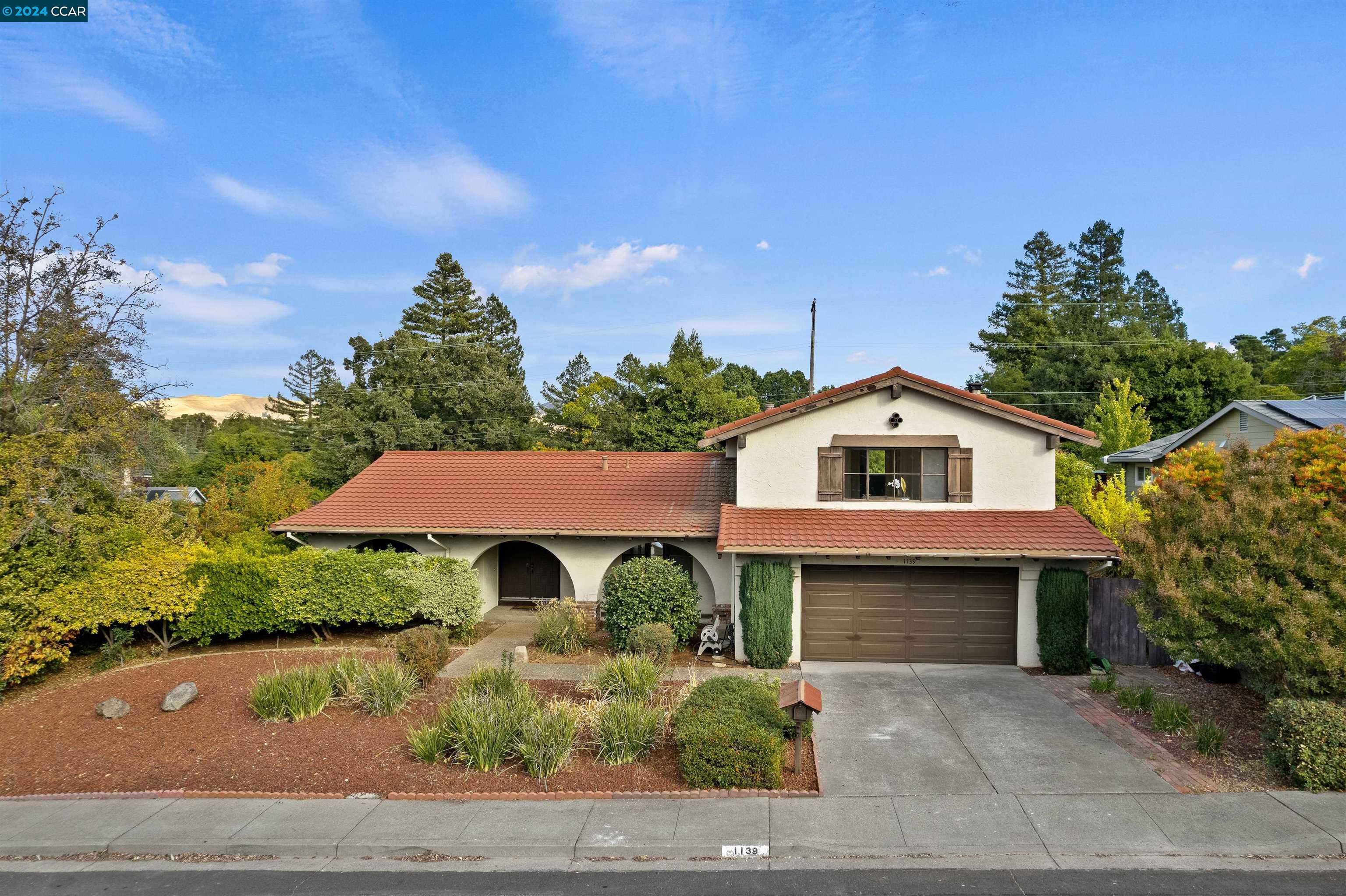 a front view of a house with garden