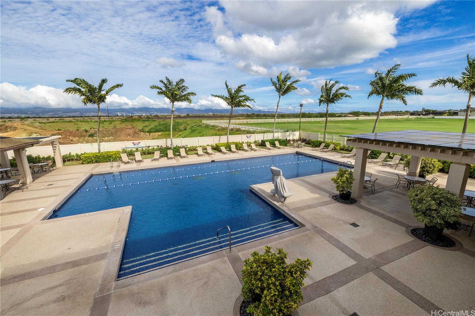 a view of swimming pool with outdoor seating and plants