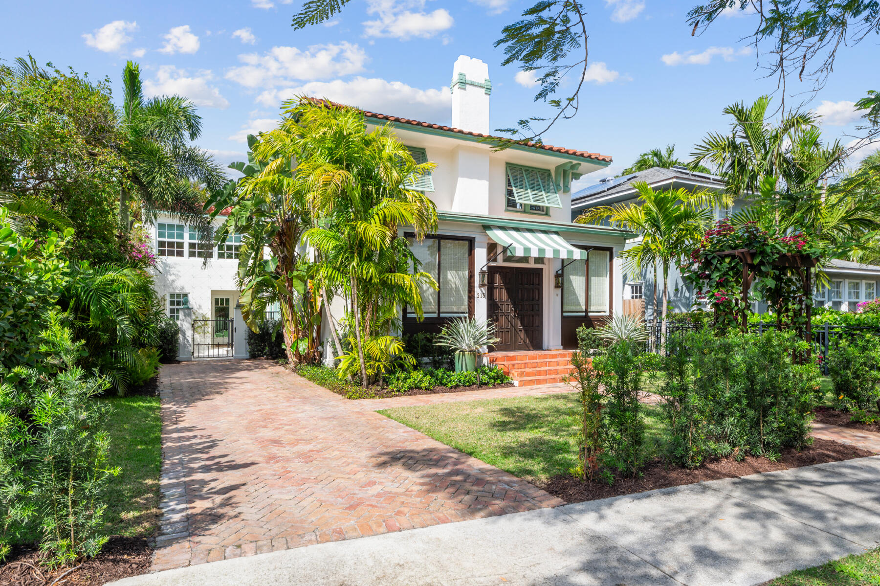 a front view of a house with garden