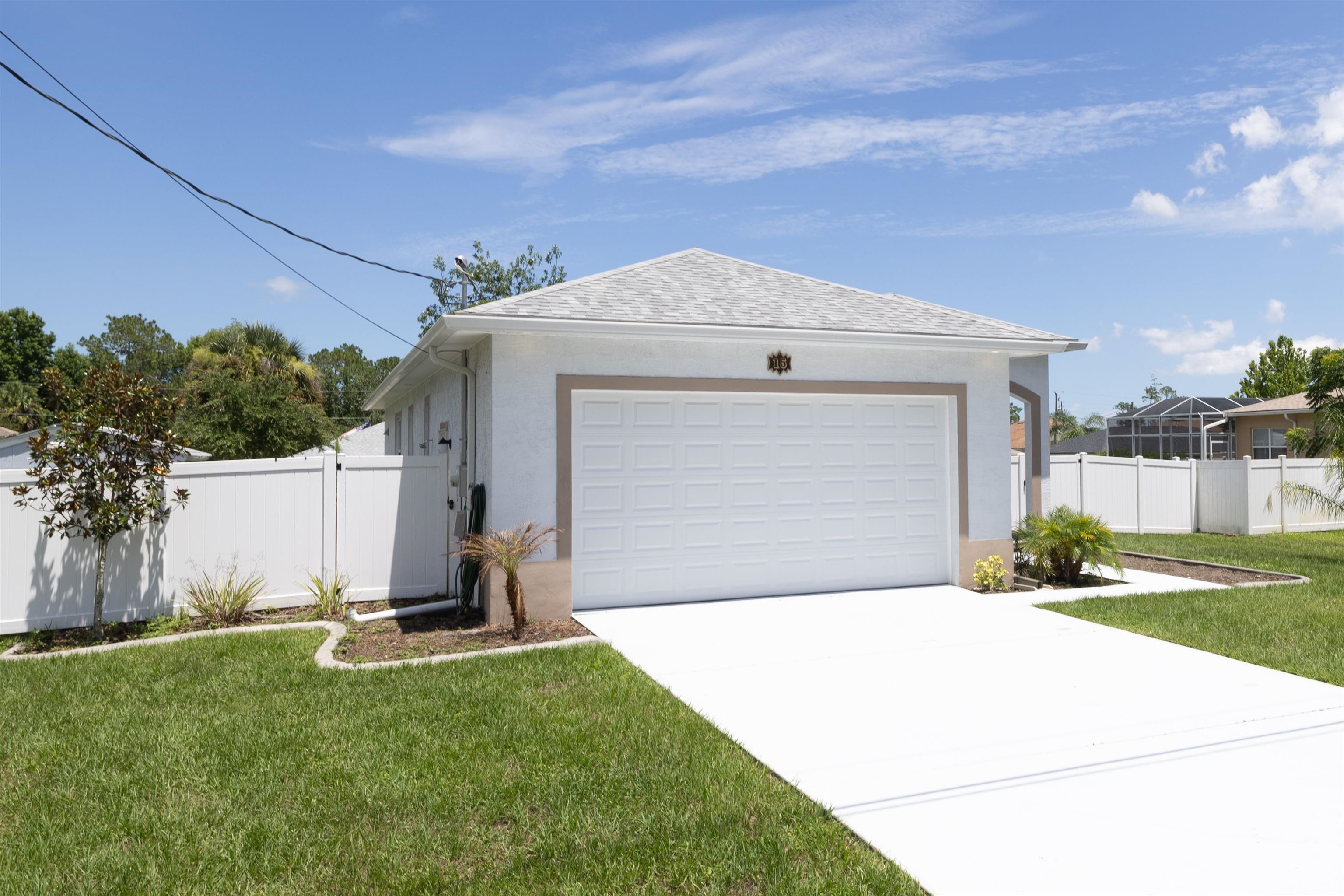 a view of a house with a yard and garage