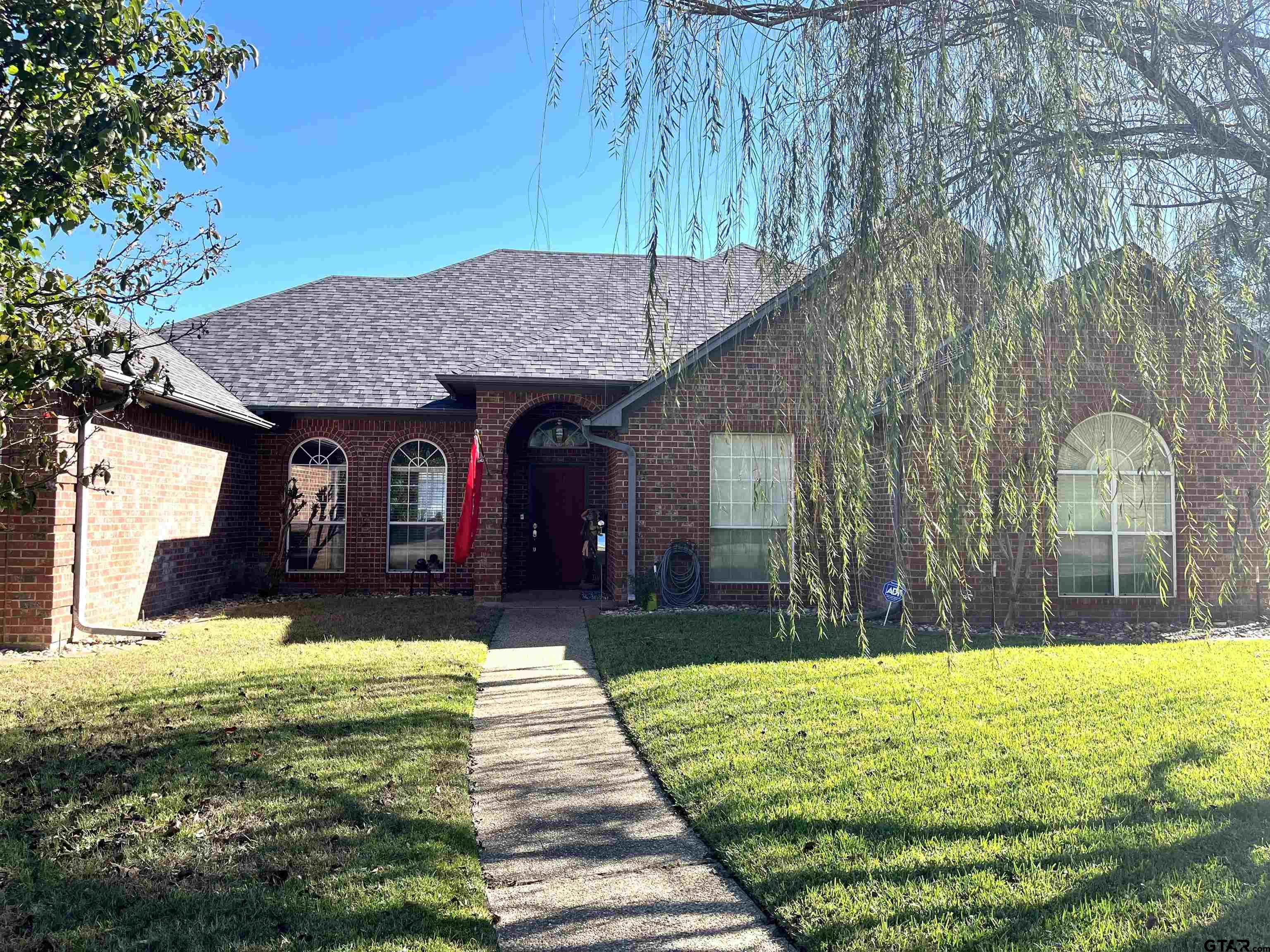 a view of a house with swimming pool and a yard