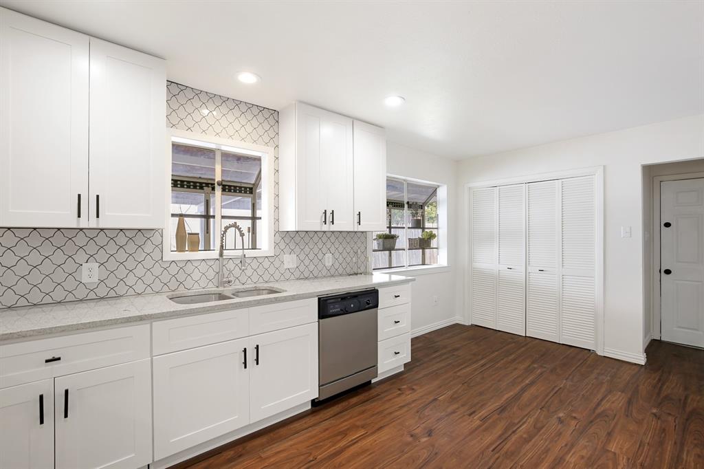 a kitchen with a sink cabinets and wooden floor