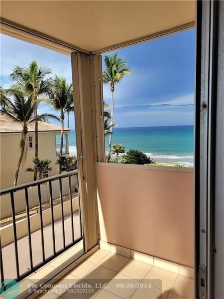 a view of balcony with wooden floor