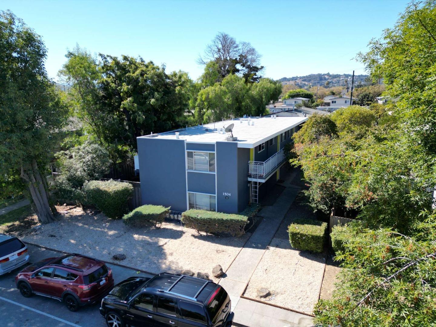 an aerial view of a house with a yard basket ball court and outdoor seating