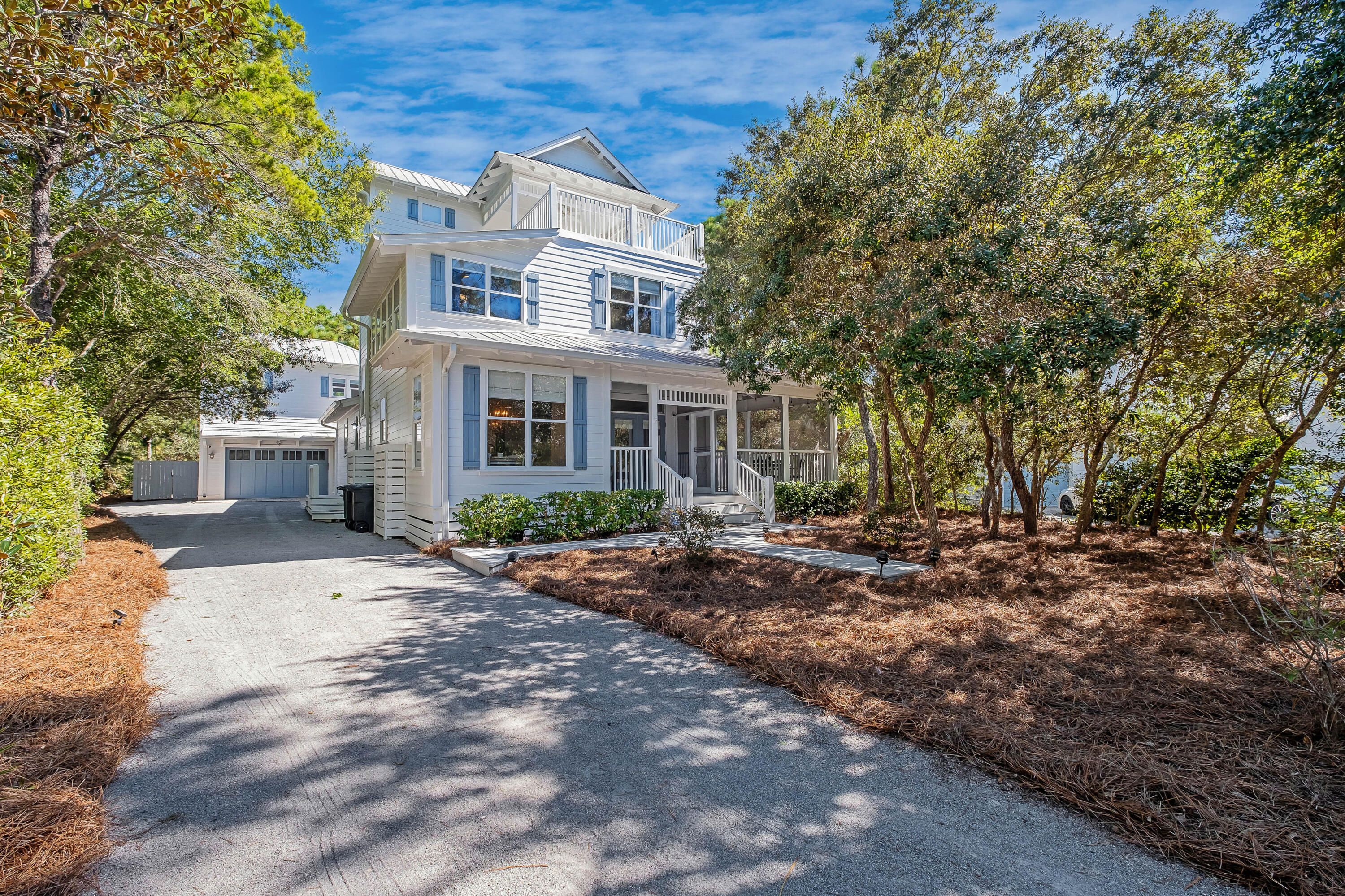 a front view of a house with a yard and shrubs