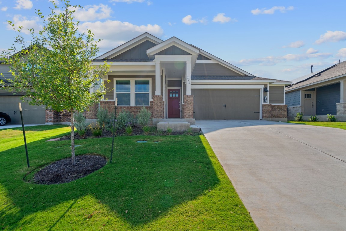 a front view of a house with garden and porch