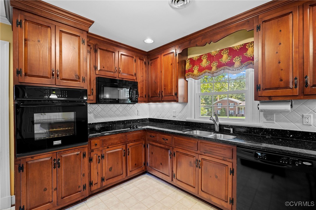 a kitchen with stainless steel appliances granite countertop wooden cabinets and a stove top oven