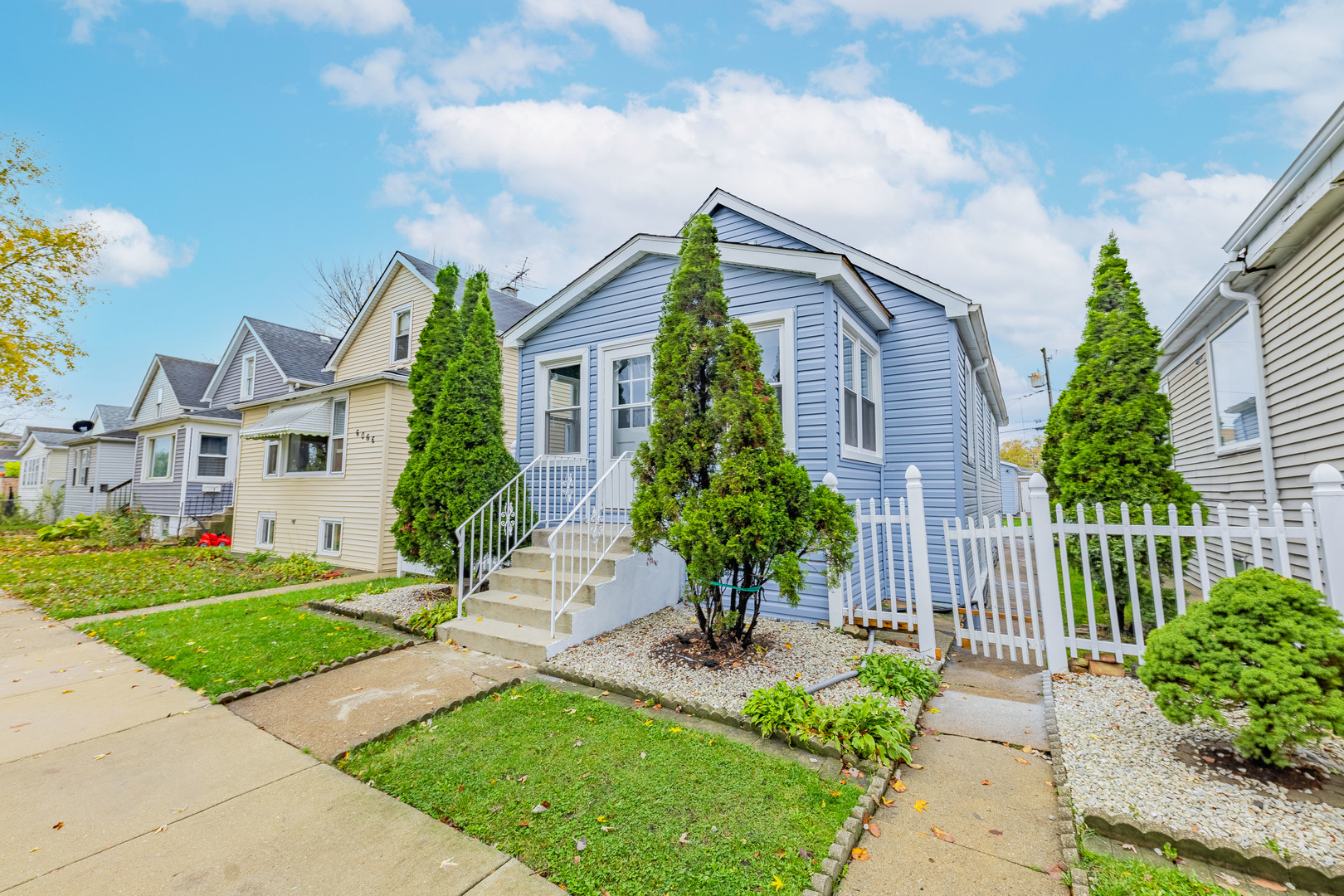 a front view of a house with a garden