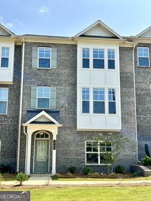 a front view of a house with a yard