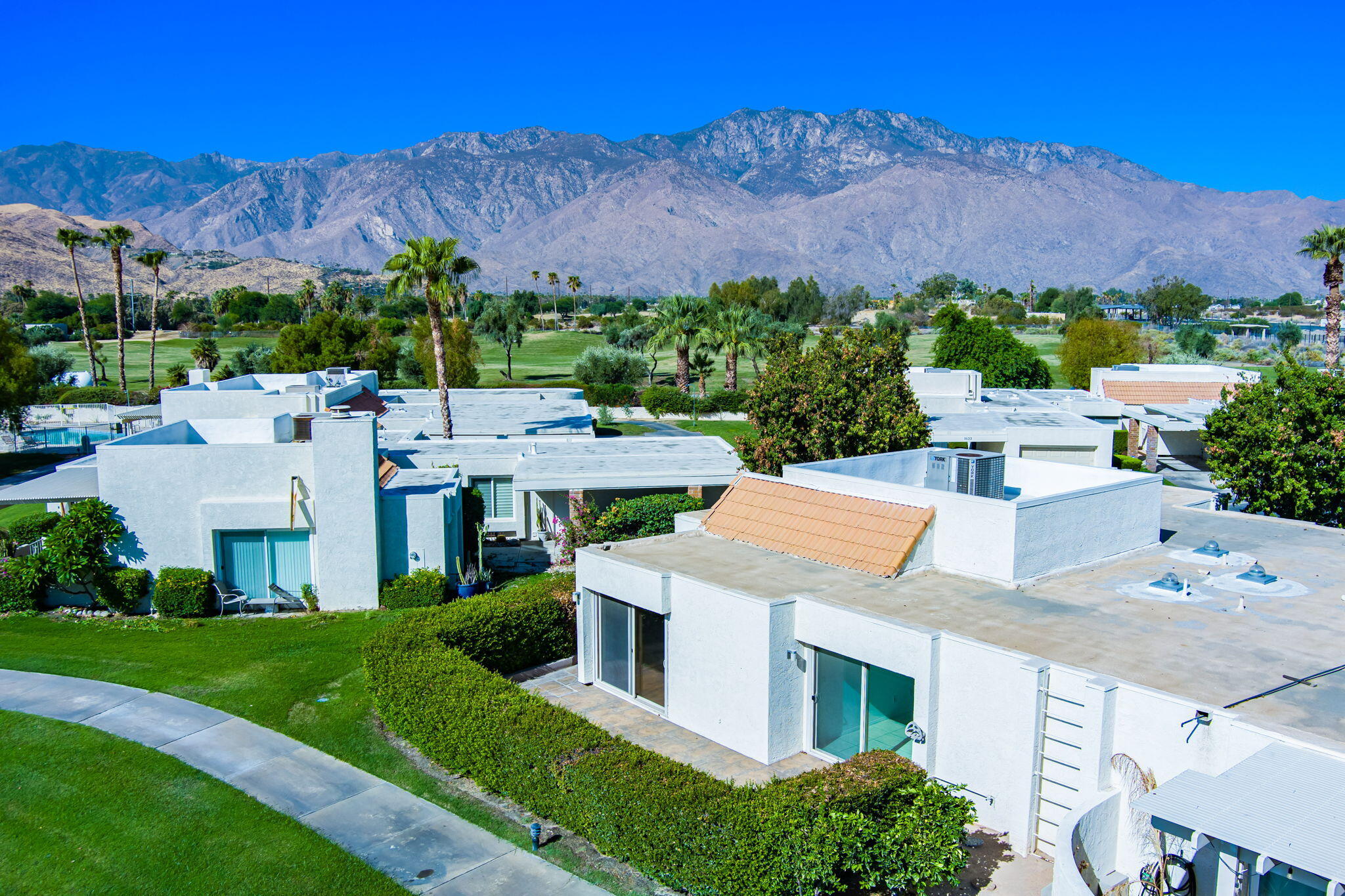 a view of a house with a yard and a mountain view