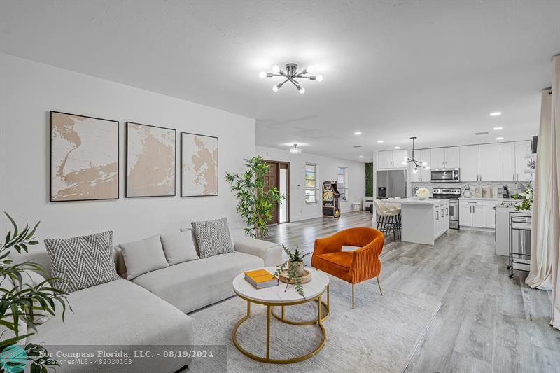 a living room with furniture and kitchen view