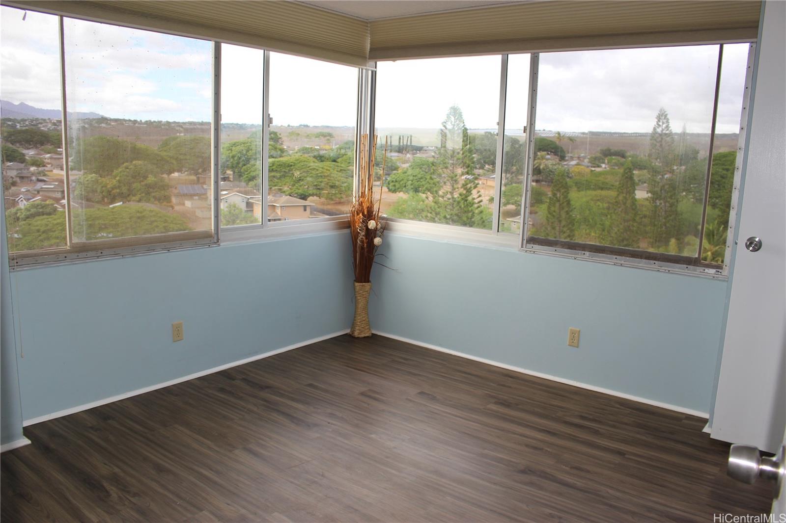 an empty room with wooden floor and a window