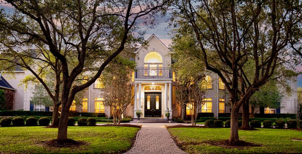 a front view of a building with trees