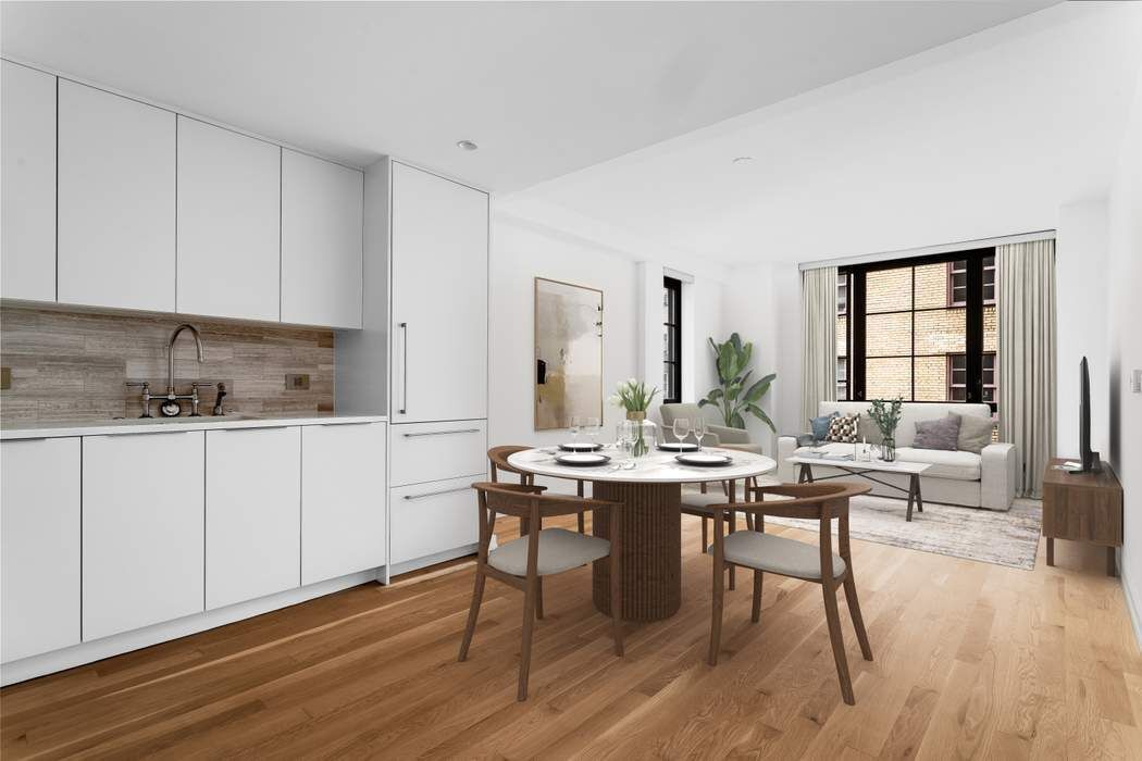 a view of a kitchen area with furniture and wooden floor