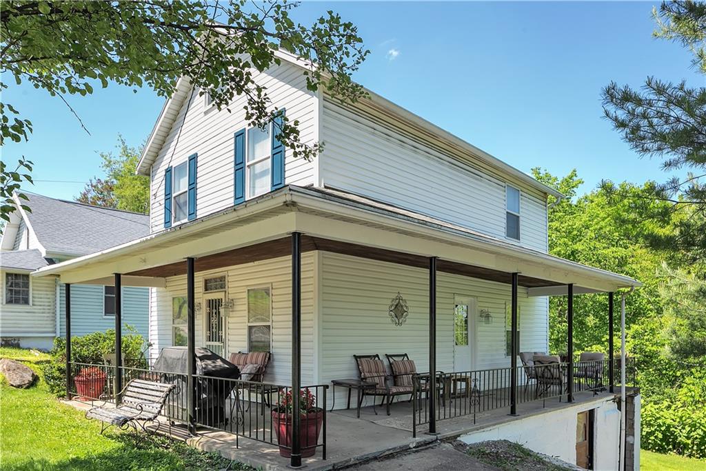 a front view of house with yard outdoor seating and green space