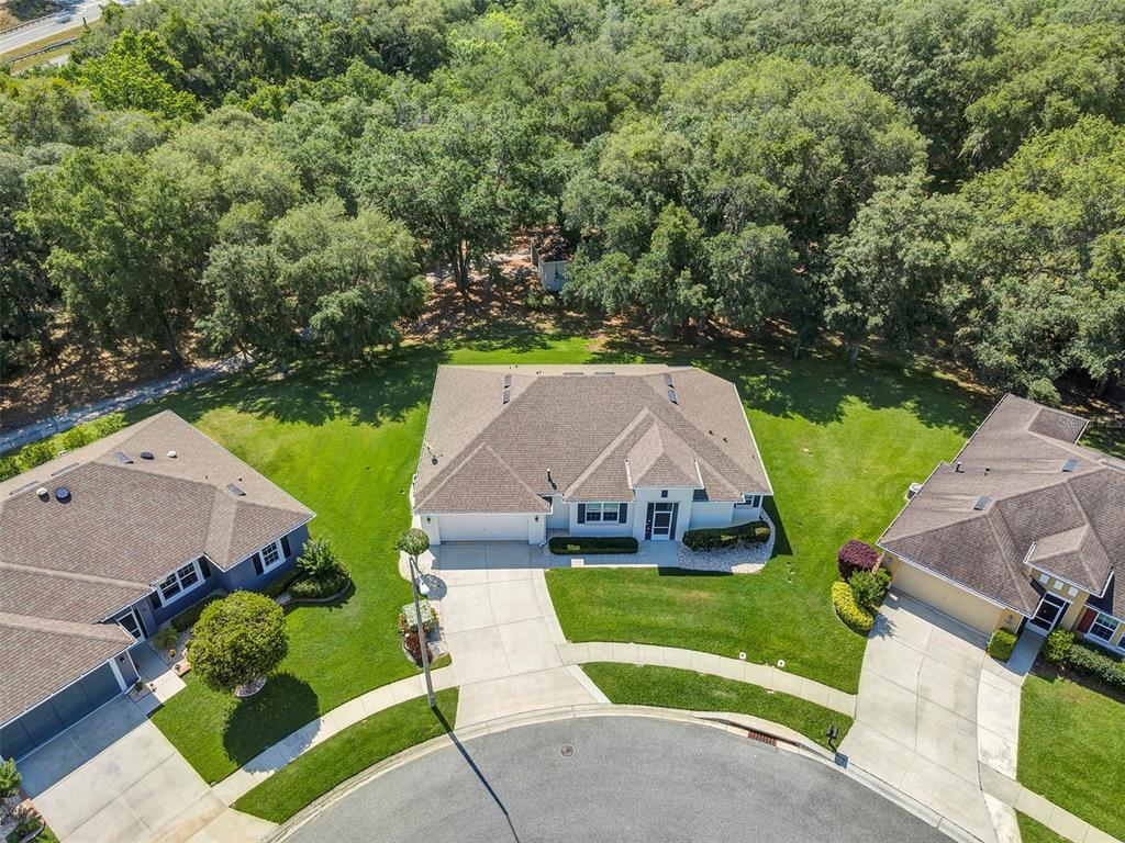 an aerial view of a house with swimming pool garden and patio