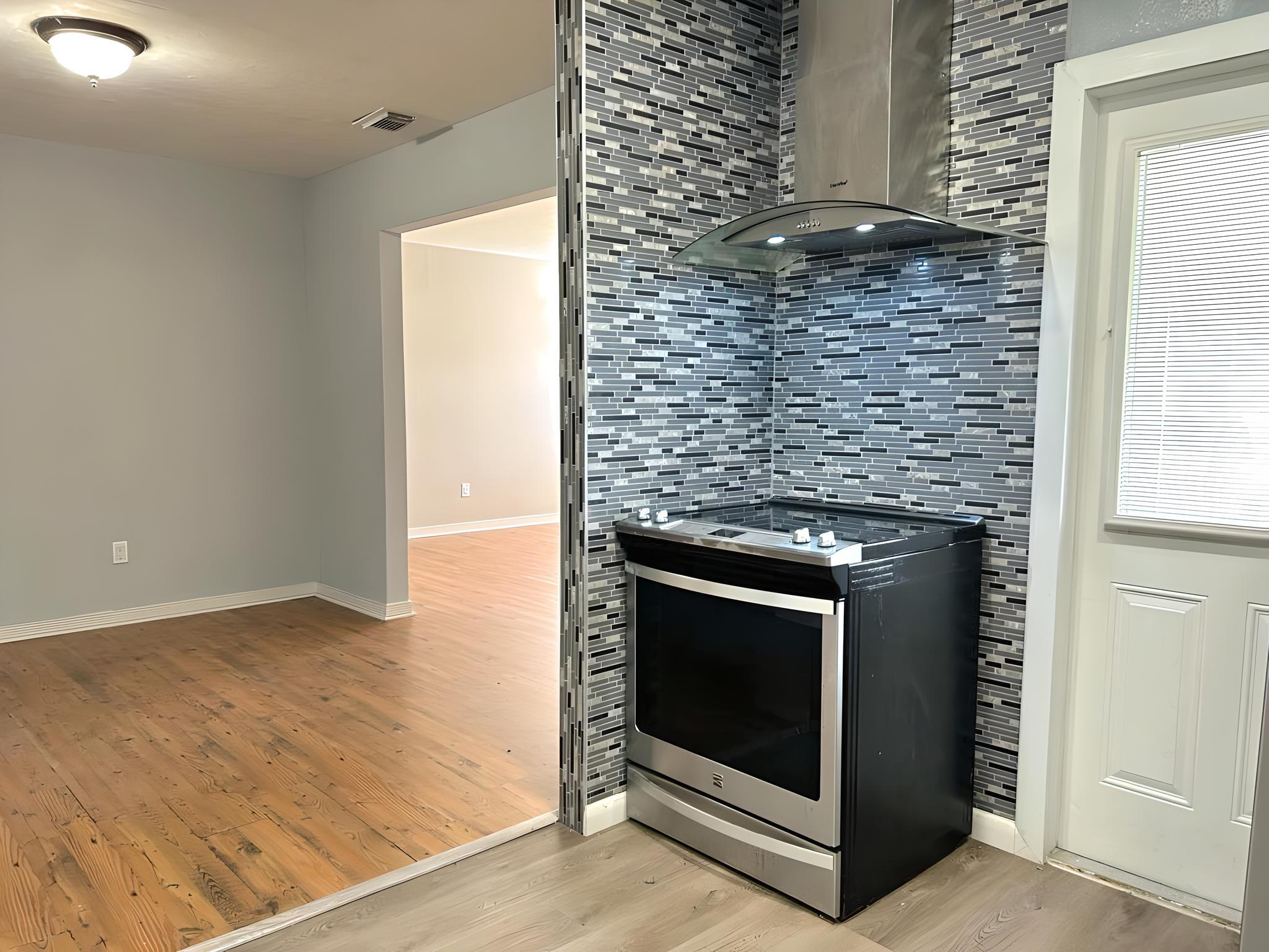 a stove top oven sitting inside of a kitchen