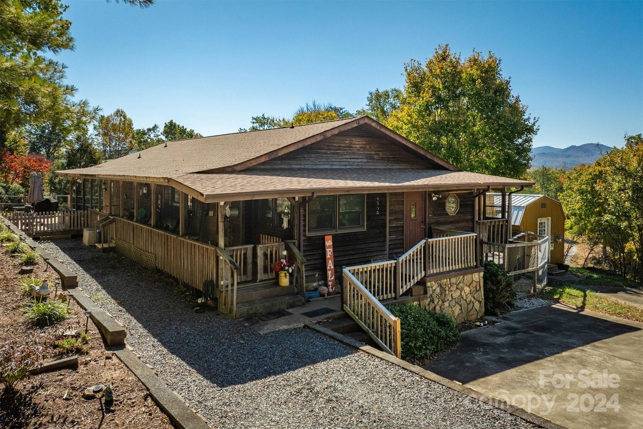 a view of a house with wooden deck front of house