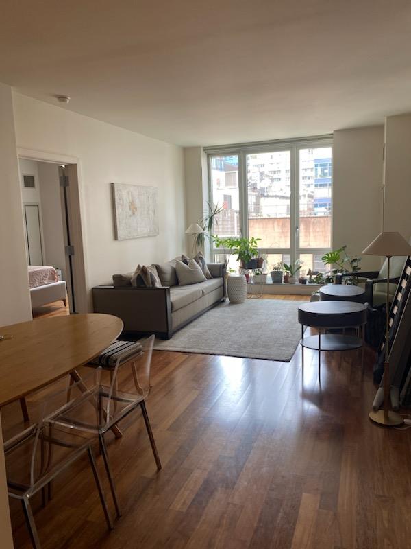 a living room with furniture a window and a table