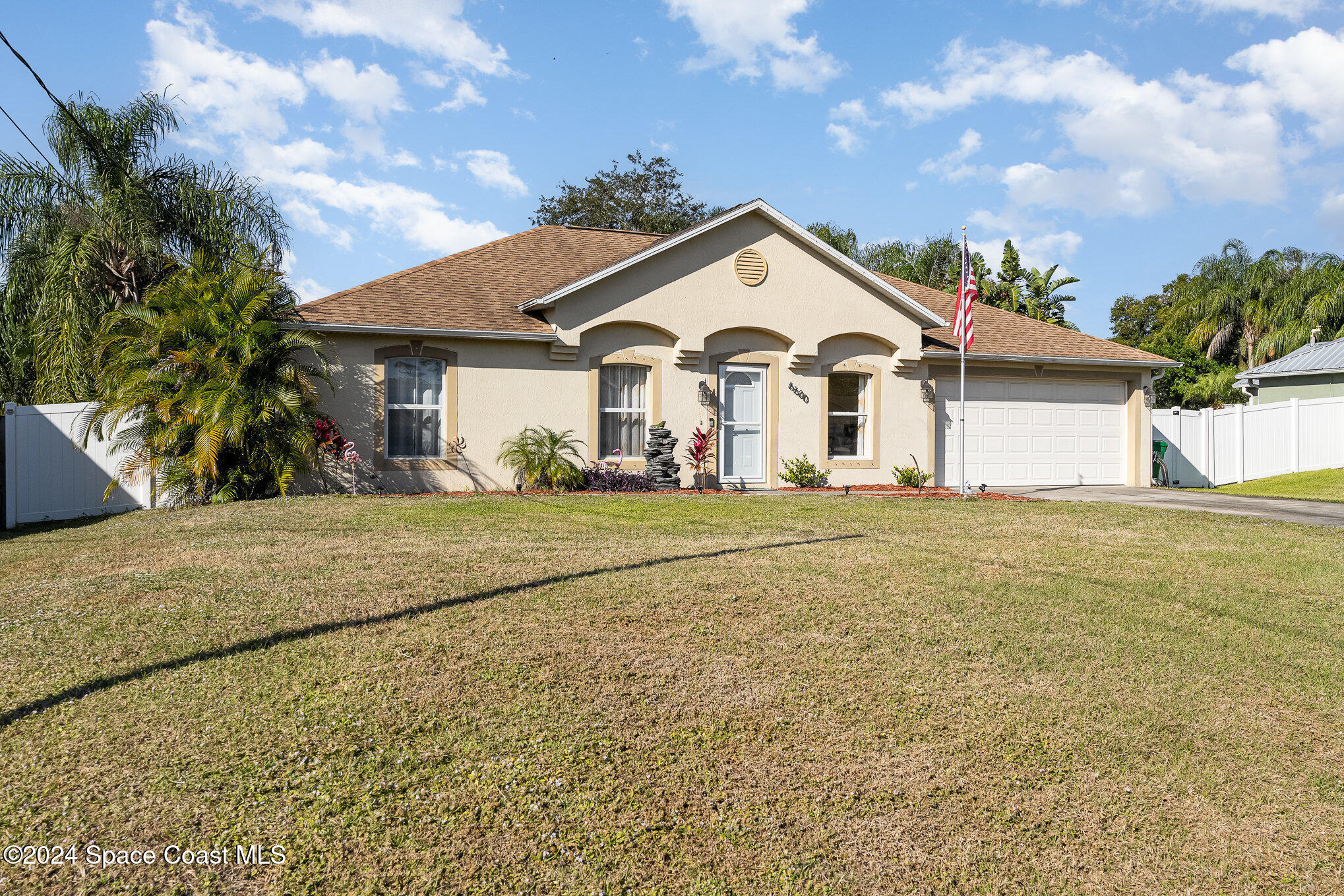 a front view of a house with a garden