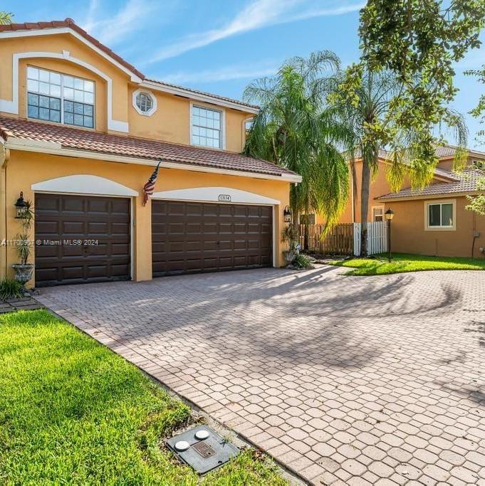 a front view of a house with a yard and garage