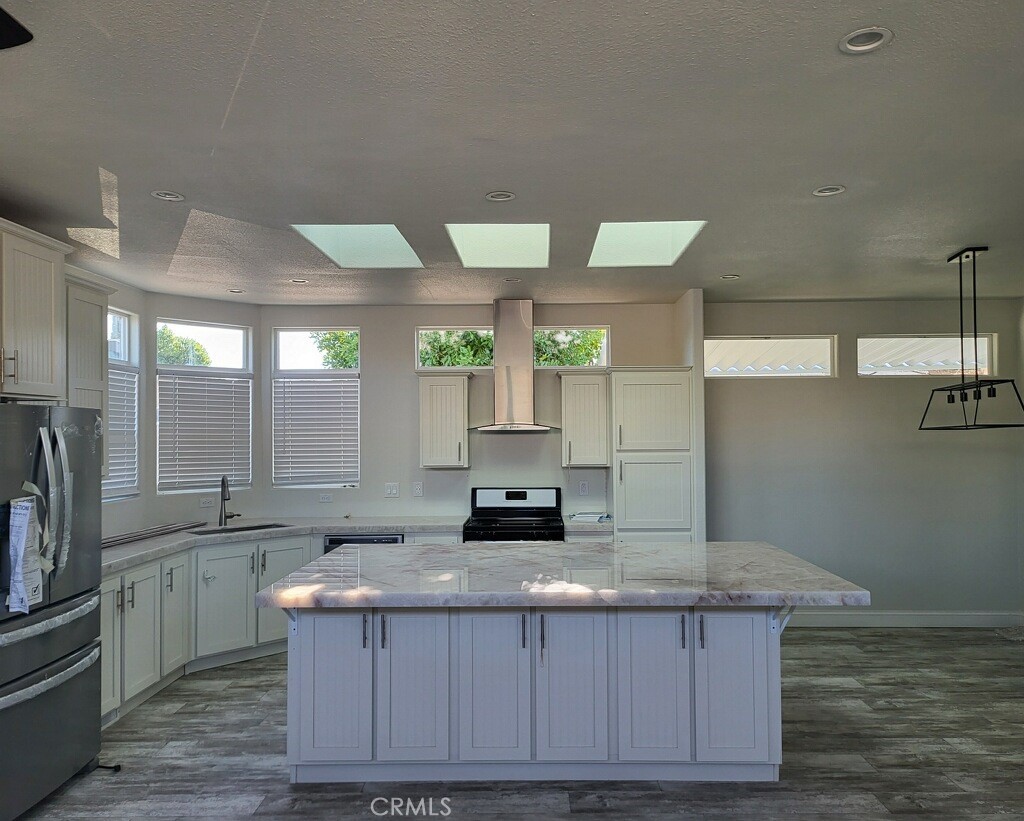 a kitchen with a sink cabinets and wooden floor