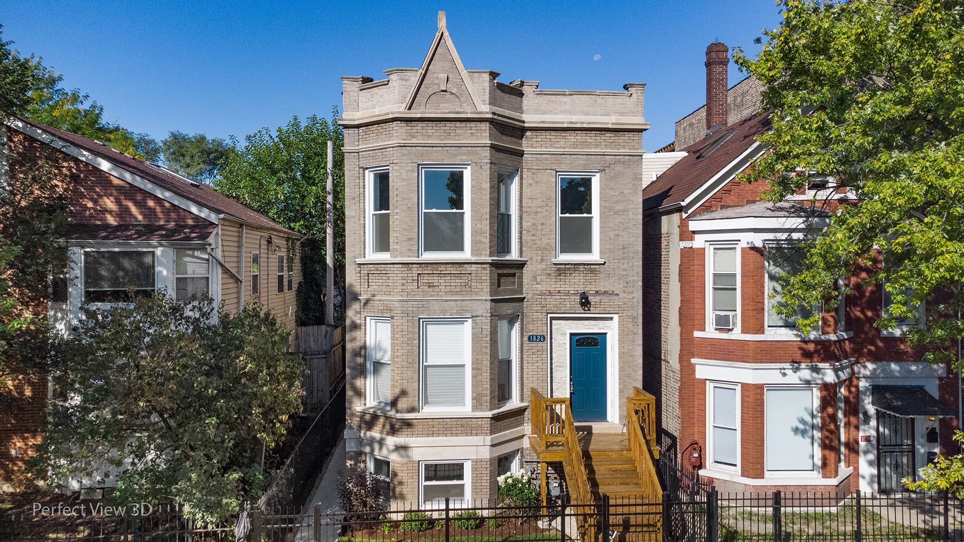 a view of a brick building next to a yard