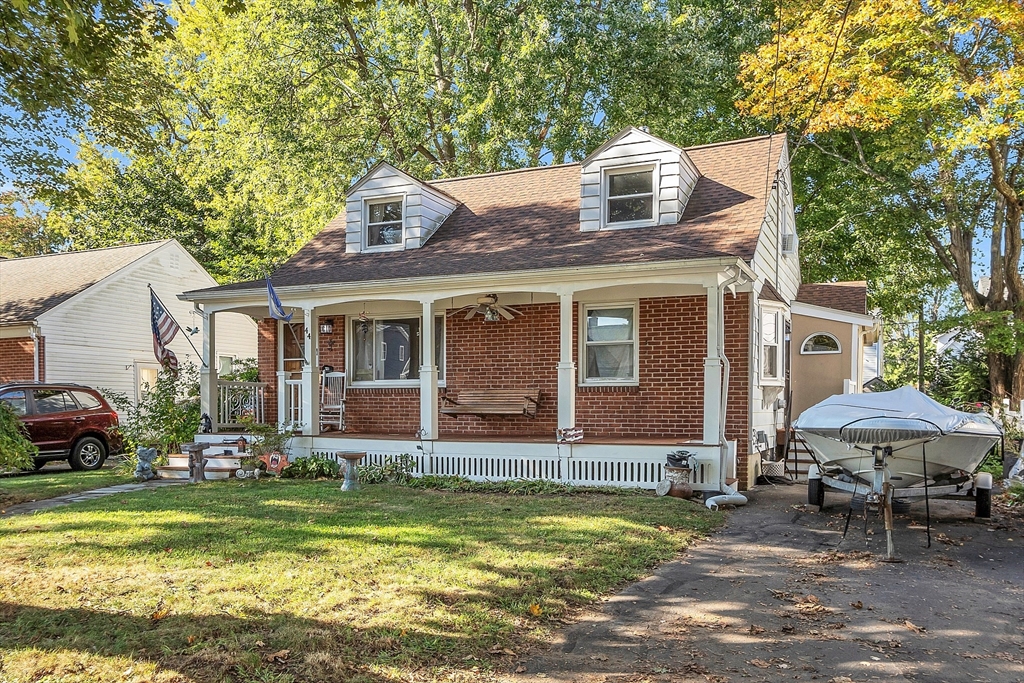 a front view of house with yard outdoor seating and barbeque oven