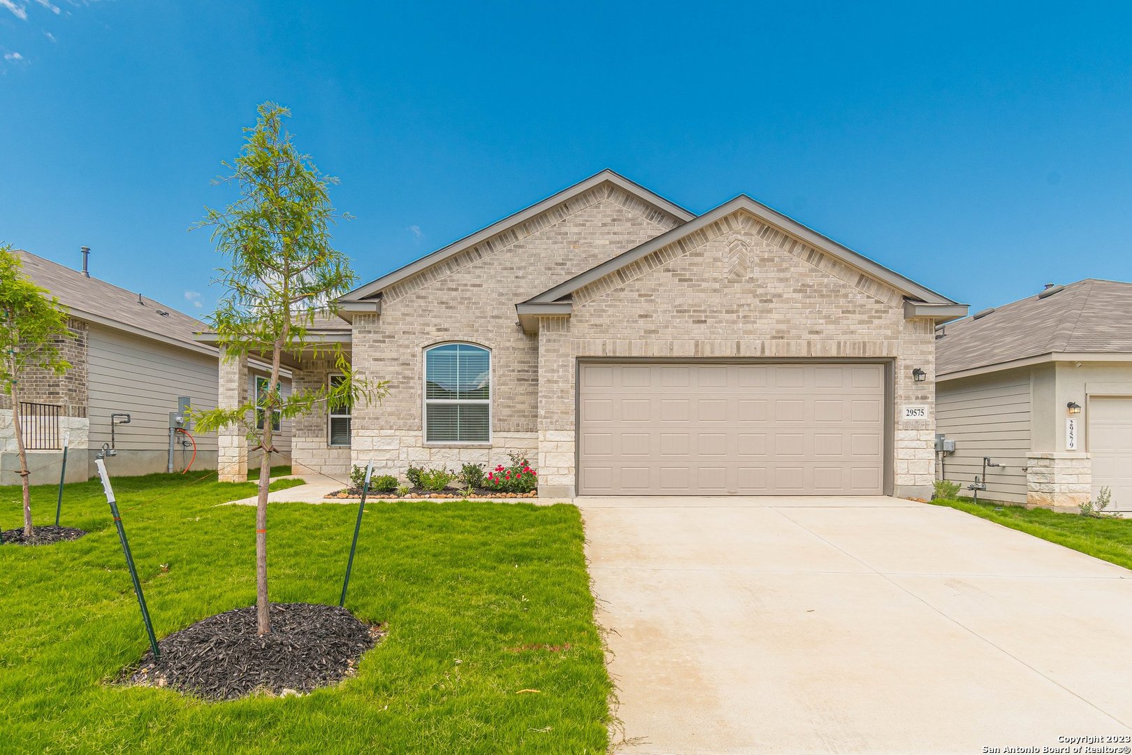 a front view of a house with a yard and garage